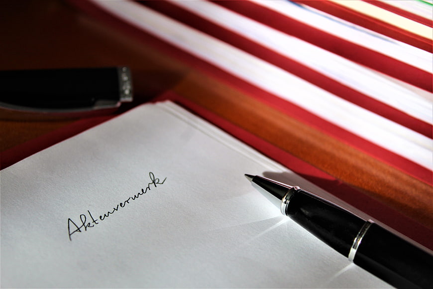 Close-up of legal files and pen on office desk