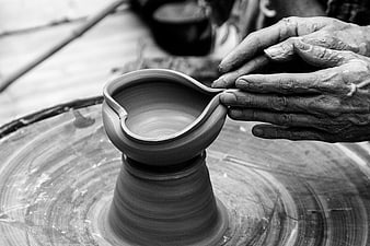 Close-up of hands shaping clay on a pottery wheel
