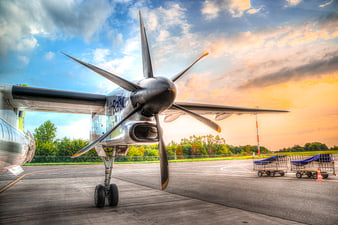 AirBaltic Propeller Plane on Airport Tarmac at Sunset