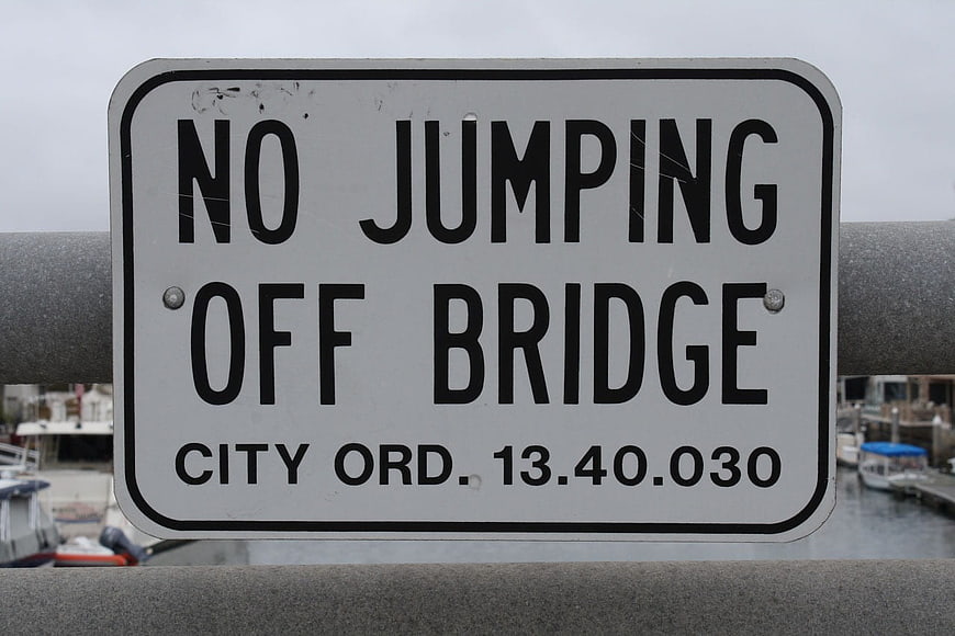 No Jumping Off Bridge Sign on Harbor Railing