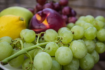 Fresh Green Grapes, Lemon, and Plum Fruit Close-Up