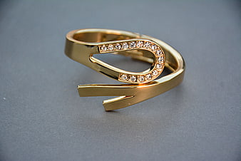 Gold Open Ring With Diamond Accents On Gray Background