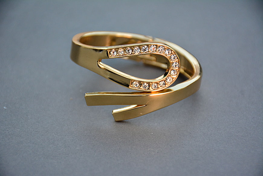 Gold Open Ring With Diamond Accents On Gray Background