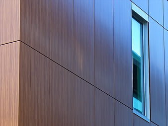 Modern building facade with wood paneling and glass window