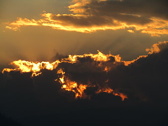 Dramatic golden sunset clouds with sun rays