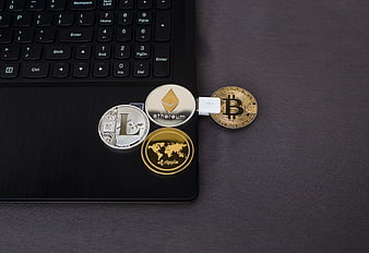 Cryptocurrency coins on laptop with USB drive