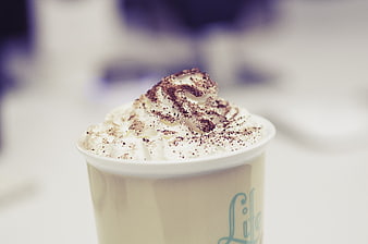 Close-up of hot chocolate with whipped cream and cocoa powder