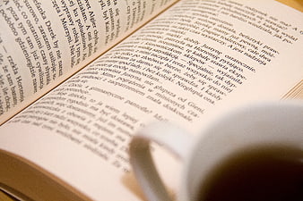 Open Book with Polish Text and Coffee Cup