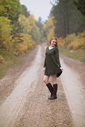 Redhead Woman in Green Dress on Autumn Forest Road