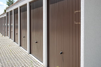 Row of brown corrugated metal storage unit doors