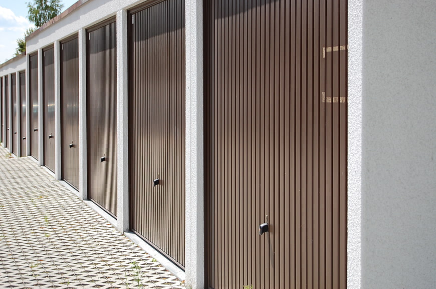Row of brown corrugated metal storage unit doors