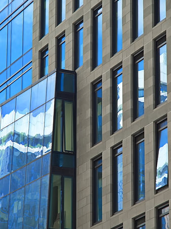 Modern Glass Building Facade with Sky Reflections