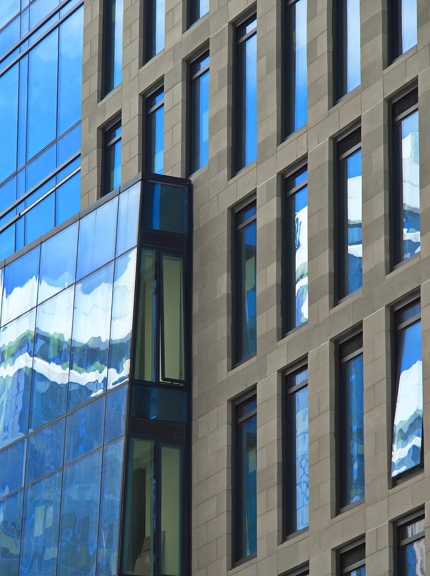 Modern Glass Building Facade with Sky Reflections
