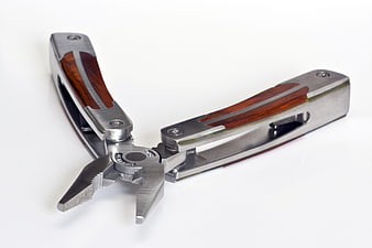 Multi-tool pliers with wooden handles on white background