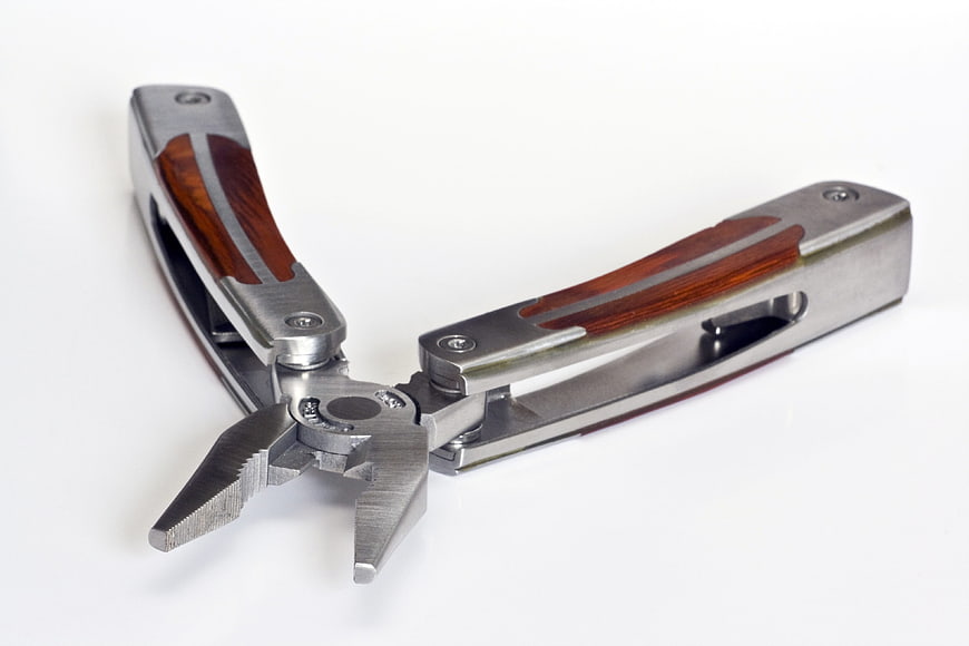 Multi-tool pliers with wooden handles on white background