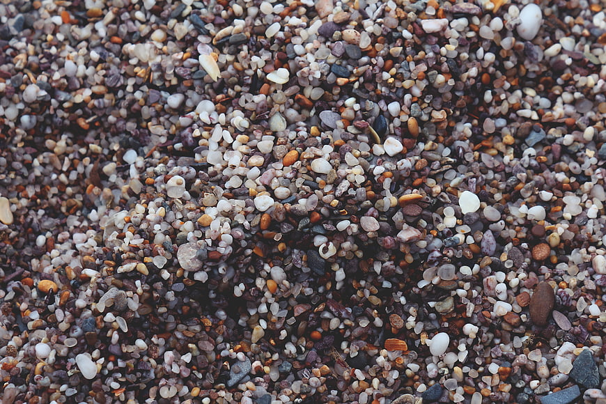 Close-up texture of multi-colored pebbles and small stones on a beach