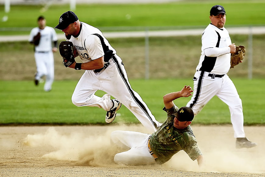 Action shot of baseball player sliding into base
