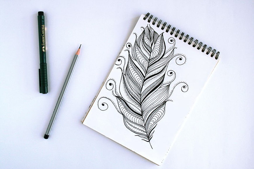Minimalist Feather Sketch in Spiral Notebook with Pen and Pencil