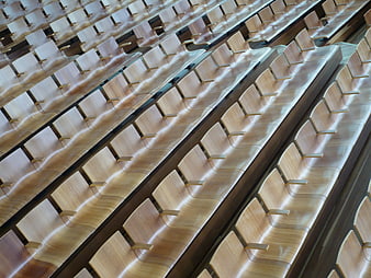 Rows of empty wooden theater seats in modern auditorium