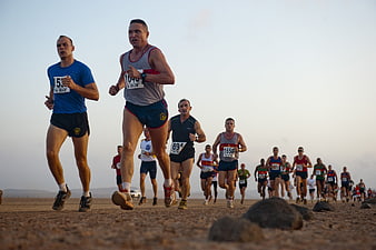 Male Runners Competing In Desert Marathon Race