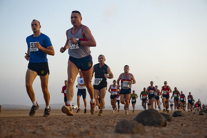 Male Runners Competing In Desert Marathon Race