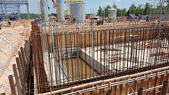 Reinforced concrete foundation construction site with rebar and formwork