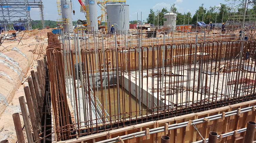 Reinforced concrete foundation construction site with rebar and formwork