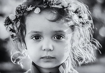 Black and white portrait of a child with a floral crown