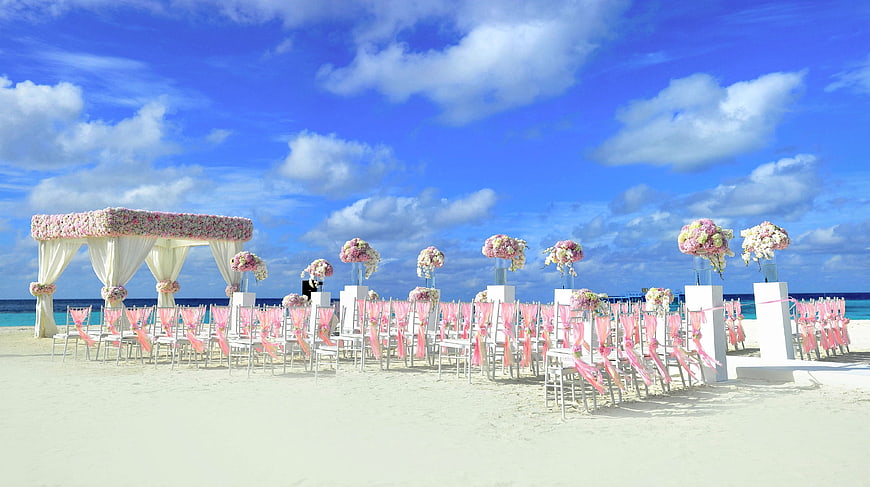 Beach Wedding Ceremony Setup With Floral Arch In Maldives