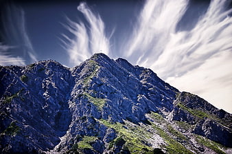 Dramatic Mountain Peak with Streaking Cirrus Clouds