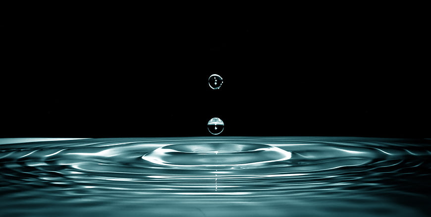 Water Droplet Splash Ripples On Black Background