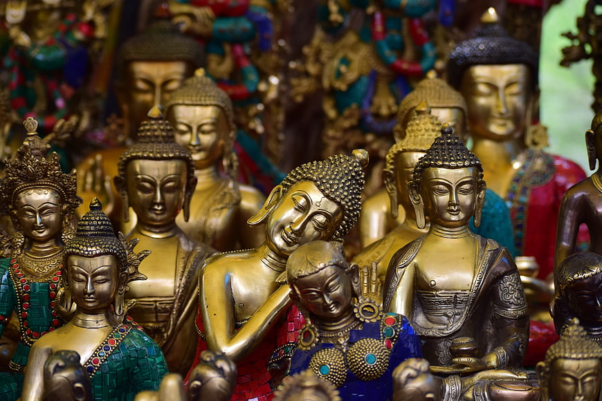 Collection of Golden Buddha Statues in a Religious Setting