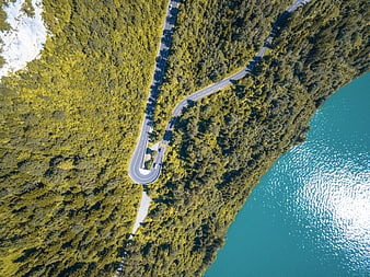 Aerial View of Winding Road Along Turquoise Lake