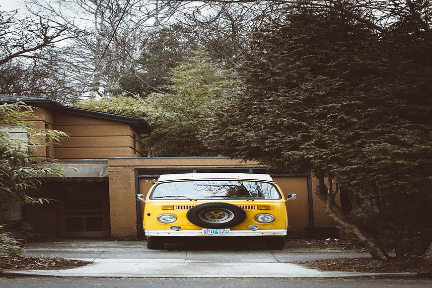 Classic Yellow Volkswagen Van Parked in Driveway