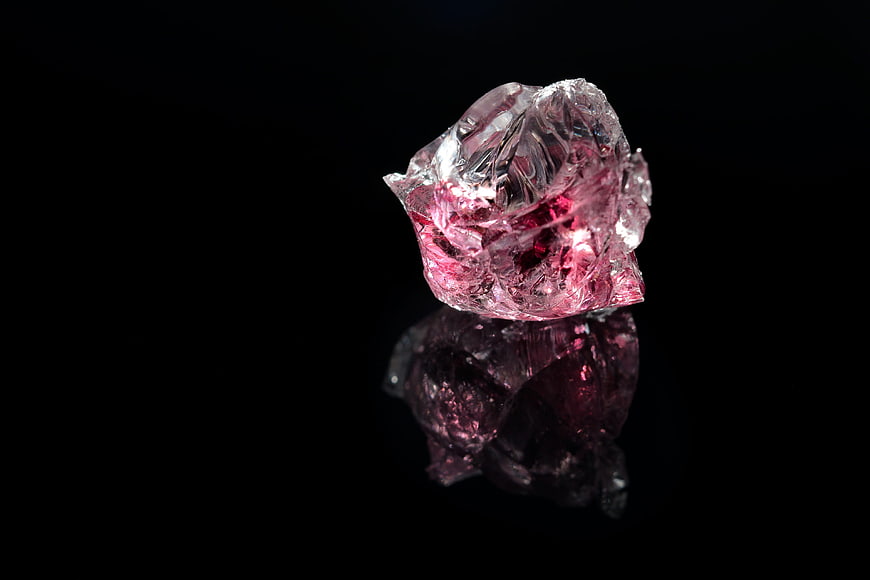 Raw Pink Crystal Gemstone on Black Background
