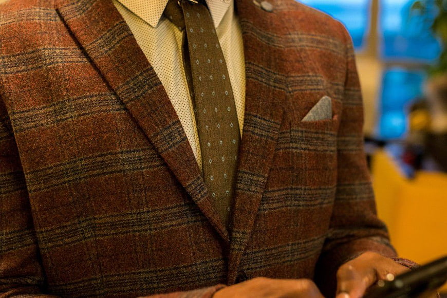 Close-up of man in brown plaid tweed suit with tie