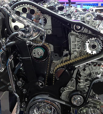 Close-up of motorcycle engine with chrome gears and timing belt