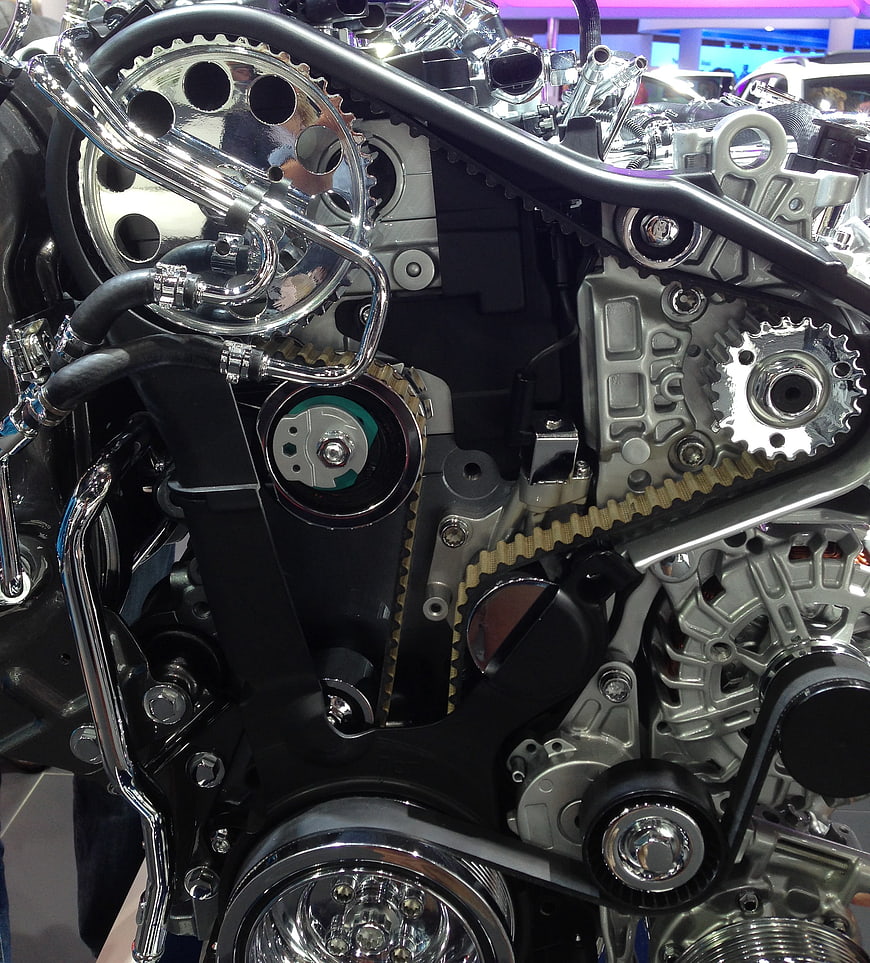 Close-up of motorcycle engine with chrome gears and timing belt