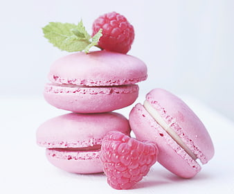Pink Raspberry Macarons with Mint Garnish on White Background