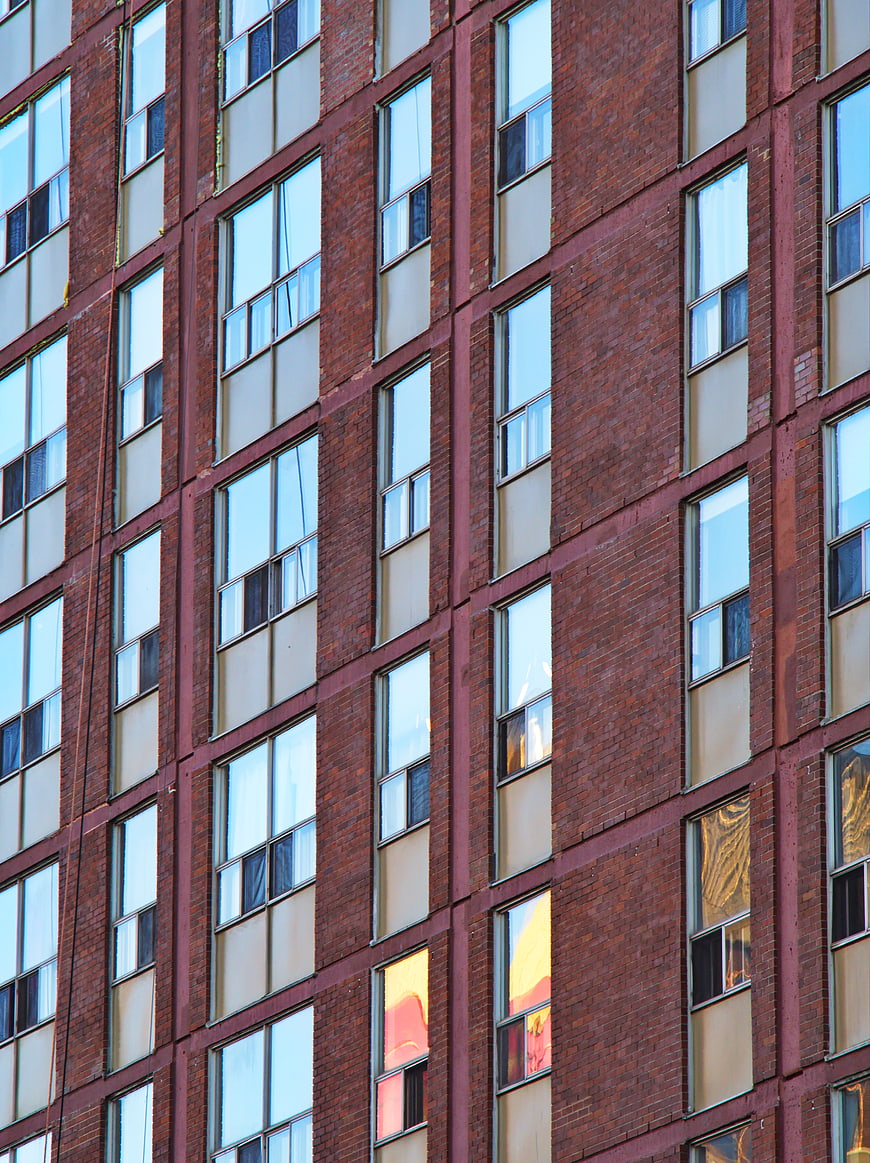 Red Brick Apartment Building Facade with Window Pattern