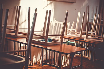 Empty Classroom with Chairs on Desks in Sunlight