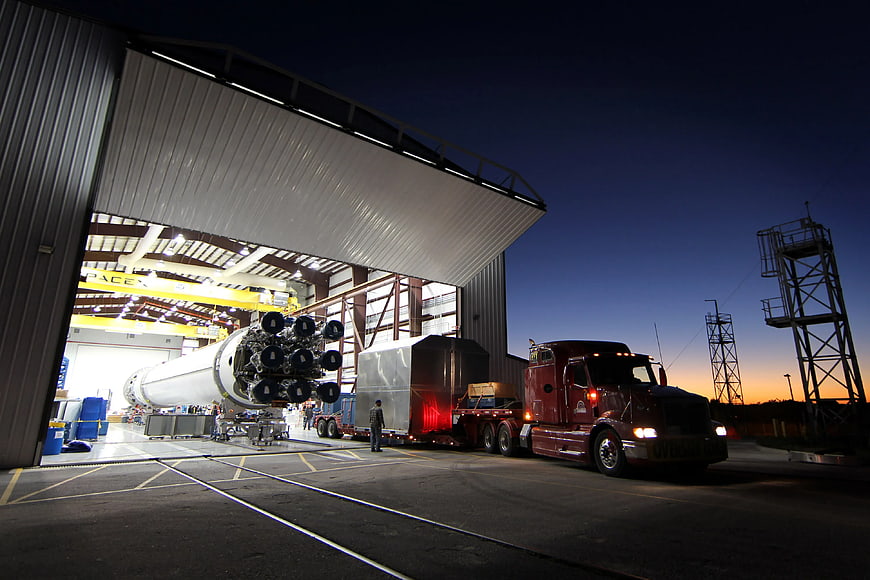 SpaceX Falcon 9 rocket transport truck at dusk