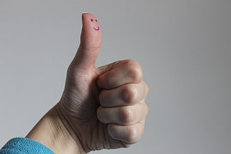 Hand Thumbs Up Gesture with Smiley Face on Thumb