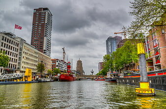 Red Ship on Urban Canal with Modern Architecture