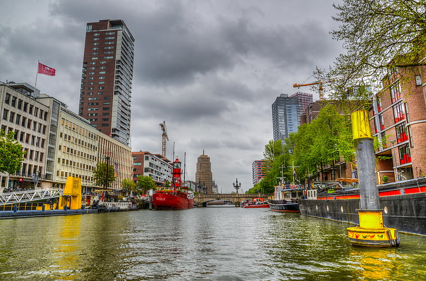 Red Ship on Urban Canal with Modern Architecture