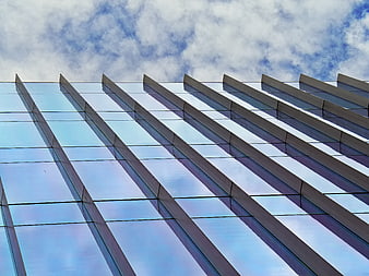 Modern Glass Building Facade with Blue Sky Reflection