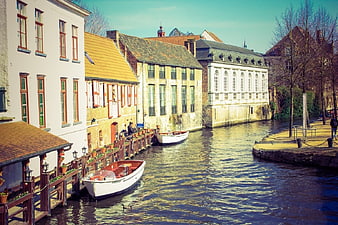 Scenic European Canal with Boats and Historic Buildings
