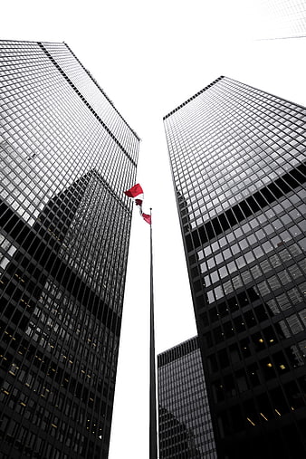 Low angle view of skyscrapers with red flag
