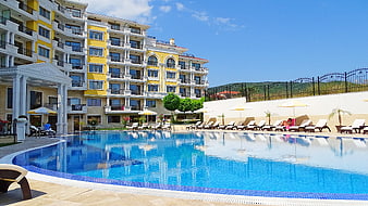 Luxury Yellow Apartment Complex With Large Swimming Pool