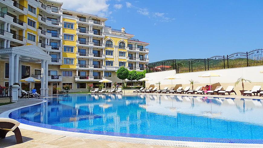 Luxury Yellow Apartment Complex With Large Swimming Pool